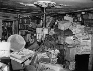 Books and newspaper bundles in the home of the Collyer<br> brothers, two of history's most infamous packrats